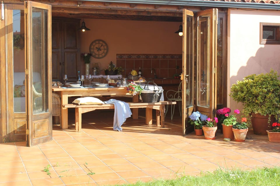 Wide porch with dining room and exterior kitchen with barbecue