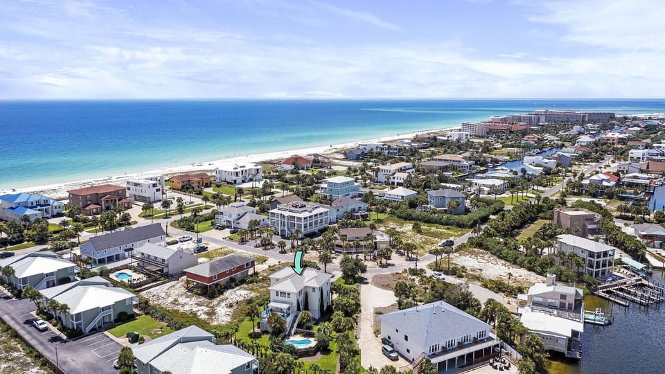 Expansive coastal view showing homes near the beach & ocean beyond

