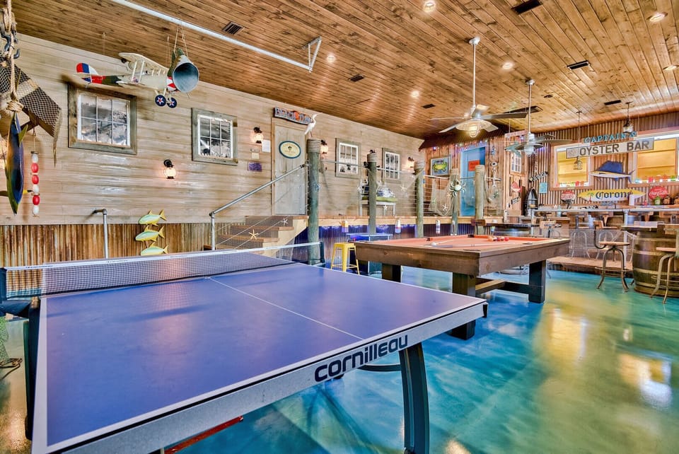 Spacious game room w/ a ping pong table and rustic coastal decor for friendly matches.