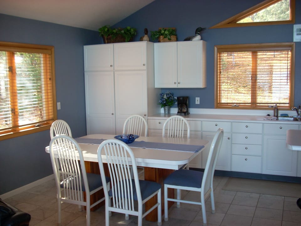 Dining table for 6 w/ seating for an additional 6 around the kitchen island.