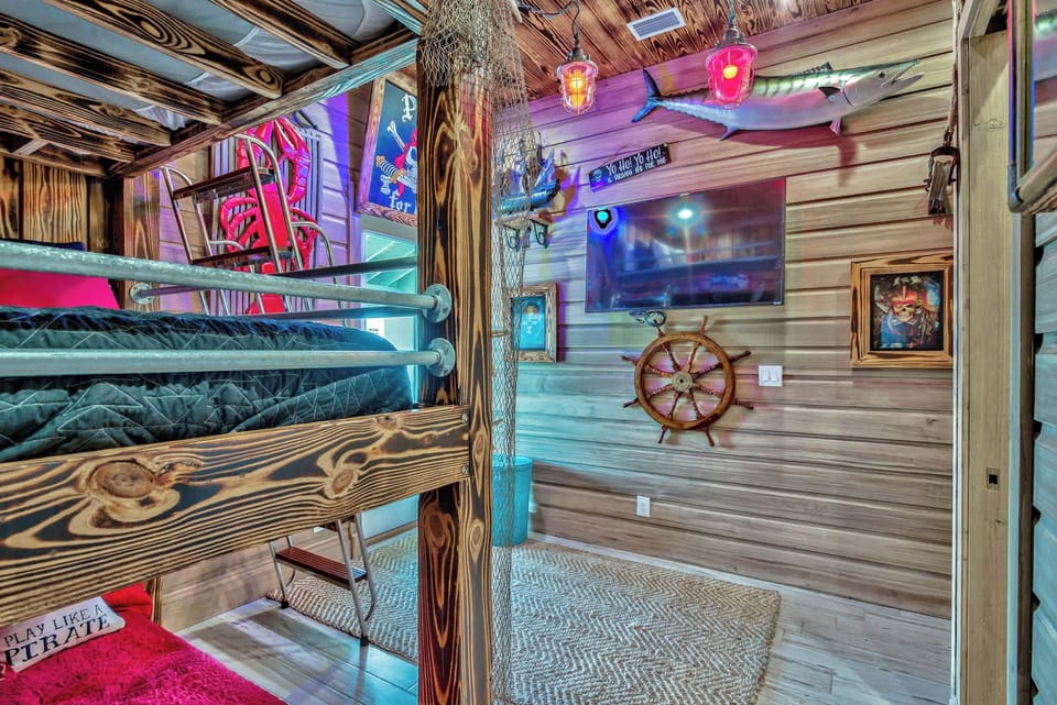 Cozy bedroom w/ bunk beds and wood-paneled walls, perfect for kids or groups