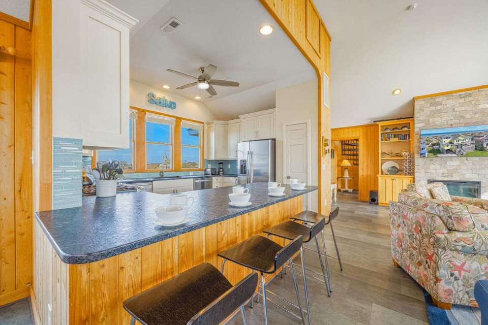 Your open-concept kitchen features granite countertops and stainless appliances, flowing seamlessly into the cozy living area with fireplace.