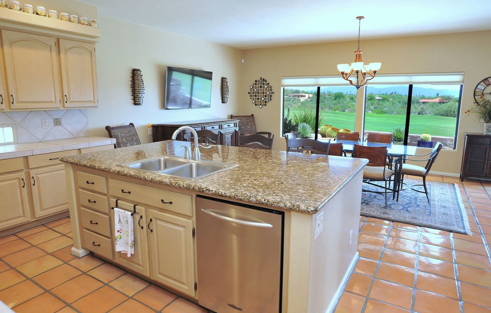 Large granite island overlooking dining area and views