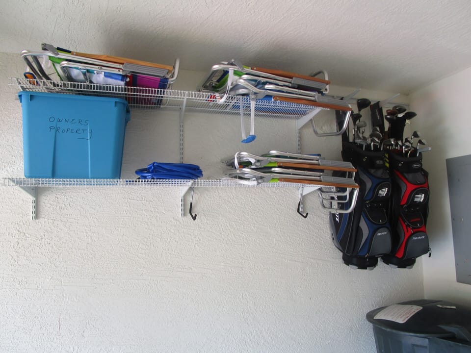 Beach chairs and golf clubs in garage