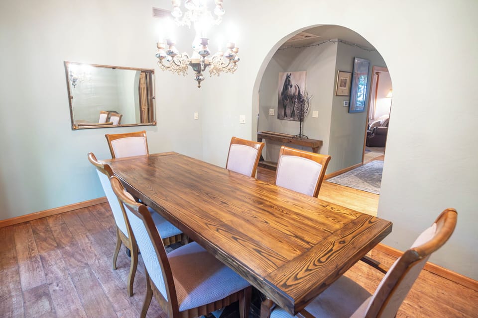 Arched entry from hallway into formal dining room.