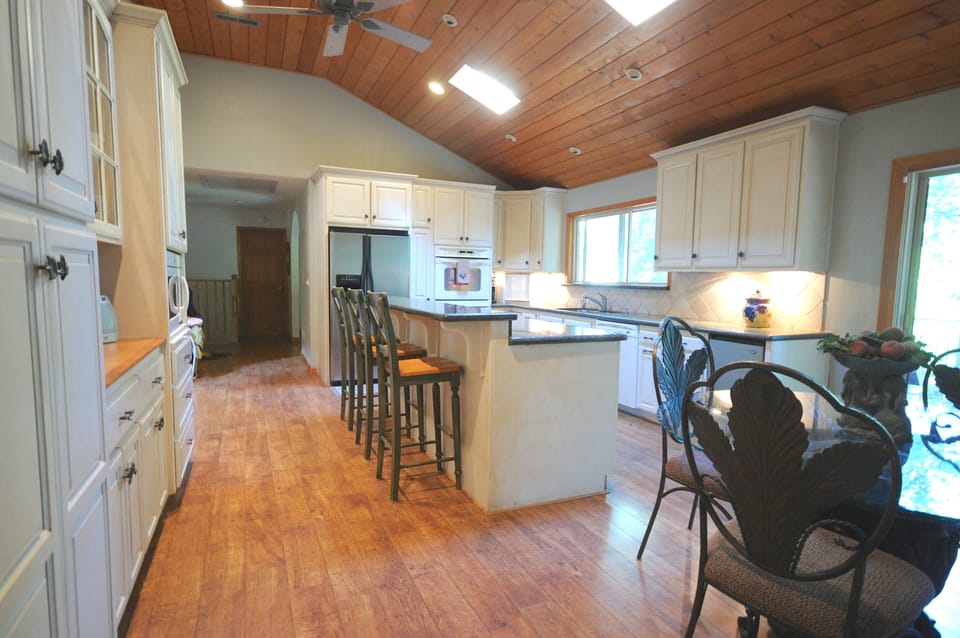Kitchen island with cooktop stove, bar seating and plenty of counter space.