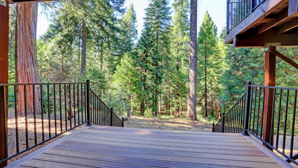 Lower back deck leads to the backyard.