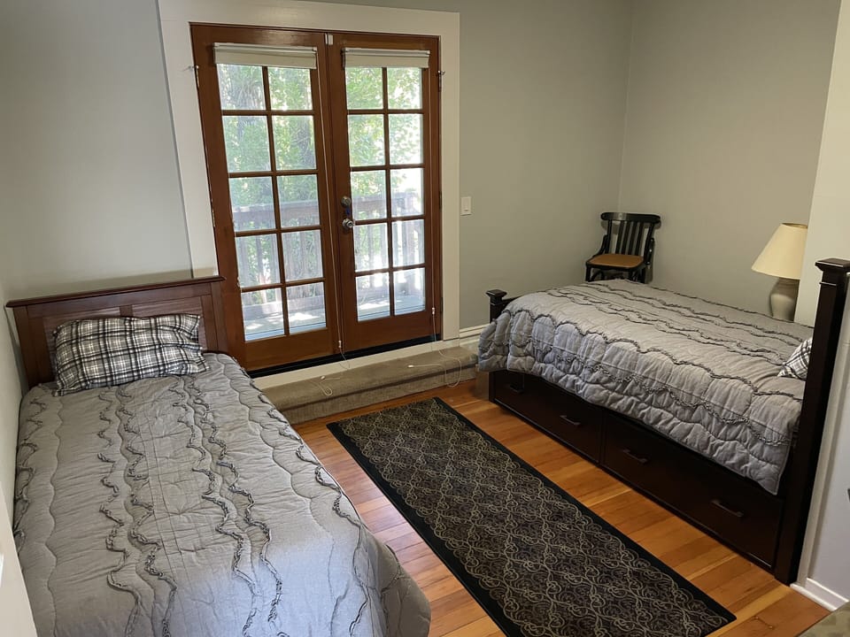 Two twin beds in second bedroom and French doors leading to private side patio.
