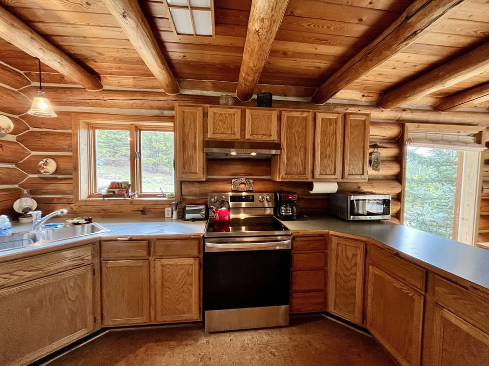 glass top range, microwave, and Grohe faucet with the kitchen sink