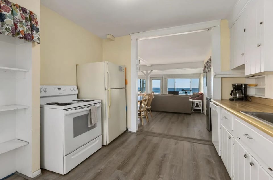 Kitchen looking toward ocean. Full size dishwasher, stove/oven and refridgerator