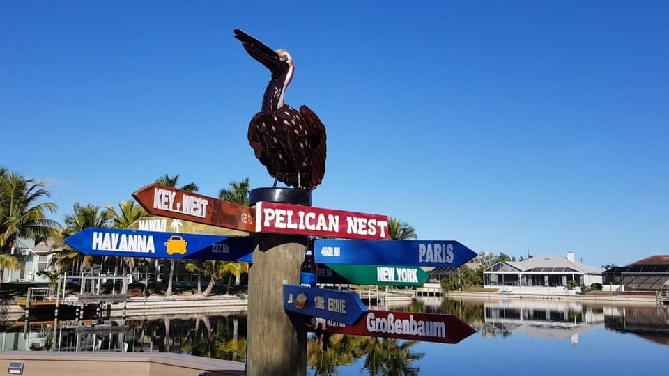 Pelican Nest with signposts to Hawaii, Key West, ....