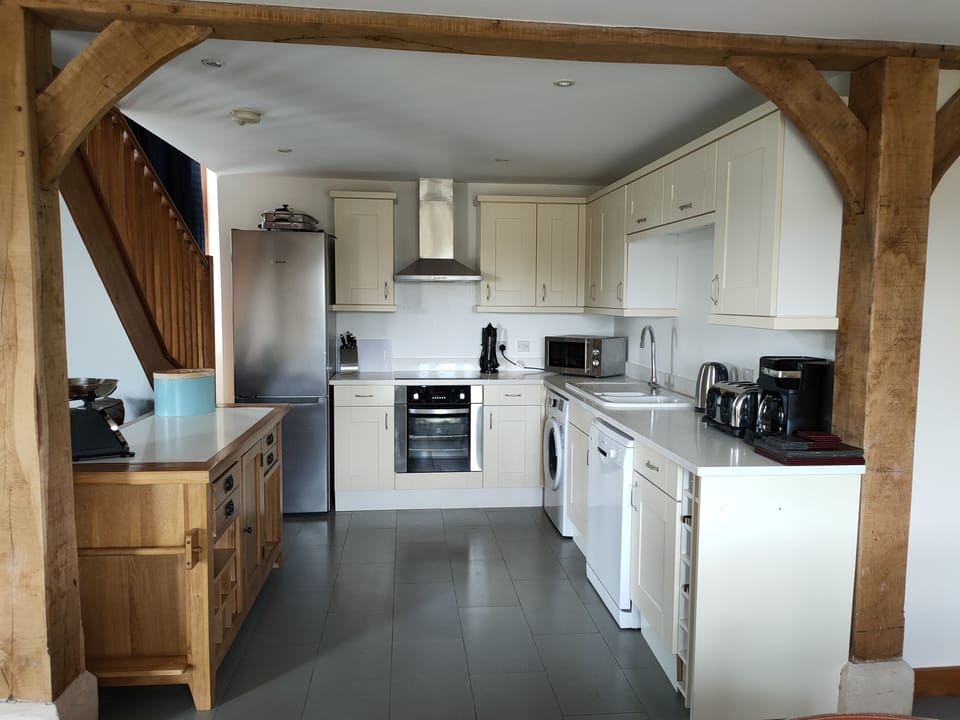 Kitchen with fridge freezer,  oven, halogen hob, dishwasher, washing machine.