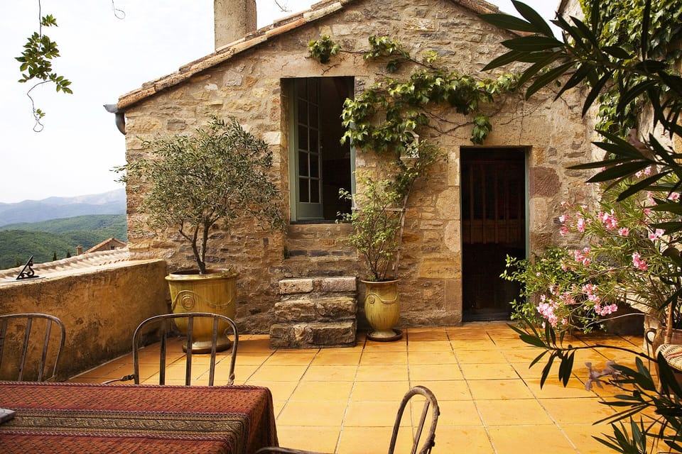 Southern Terrace with breathtaking views. An outdoor table with a wisteria.