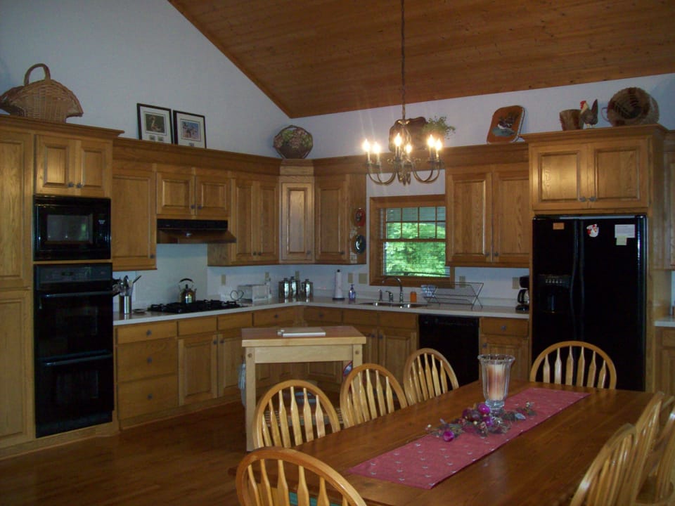 Fully equipped kitchen w/ oak cabinets, Corian tops & hand crafted dining table.