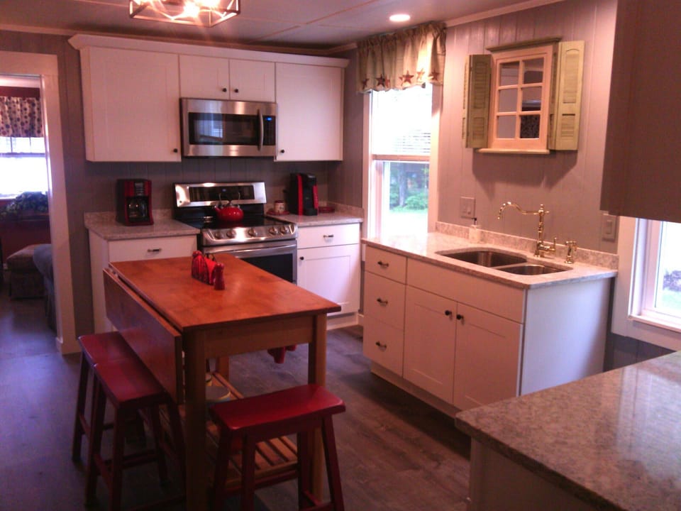 Remodeled kitchen with quartz counters and stainless steel appliances.