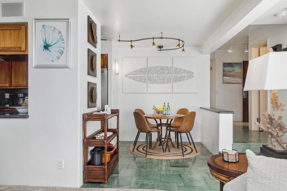 The open-concept dining area features stylish seating and elegant island décor, perfect for enjoying meals with friends and family.

