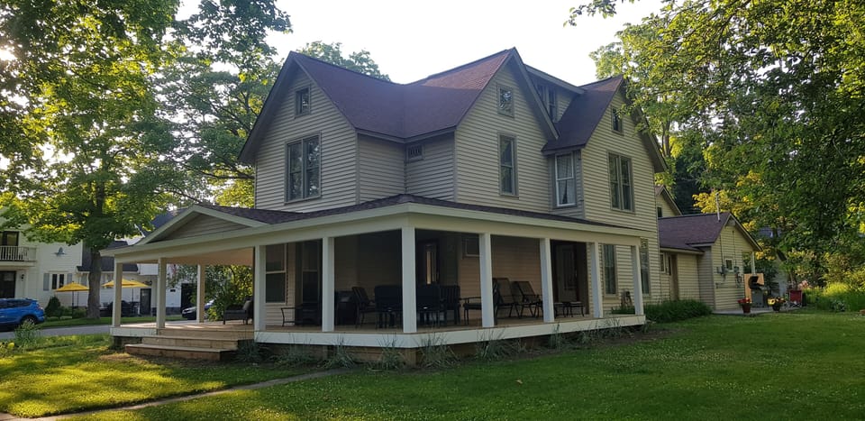 Forest House, wraparound porch with plenty of seating & tables