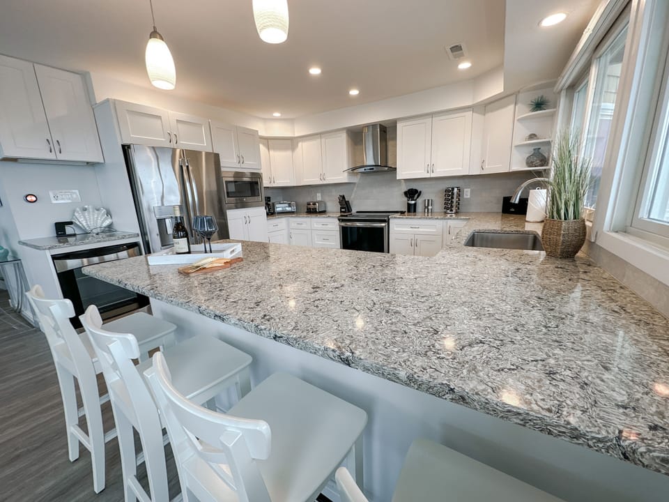 Large kitchen with quartz countertops & stainless steel appliances