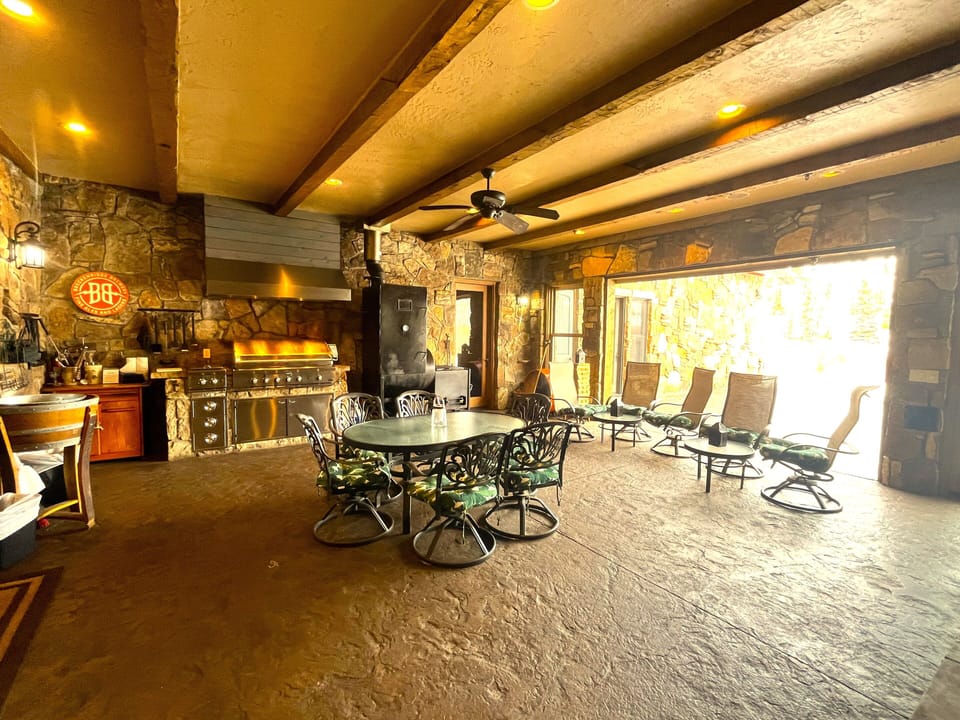 Indoor Patio Grill Area with garage style patio door to outdoor patio & firepit