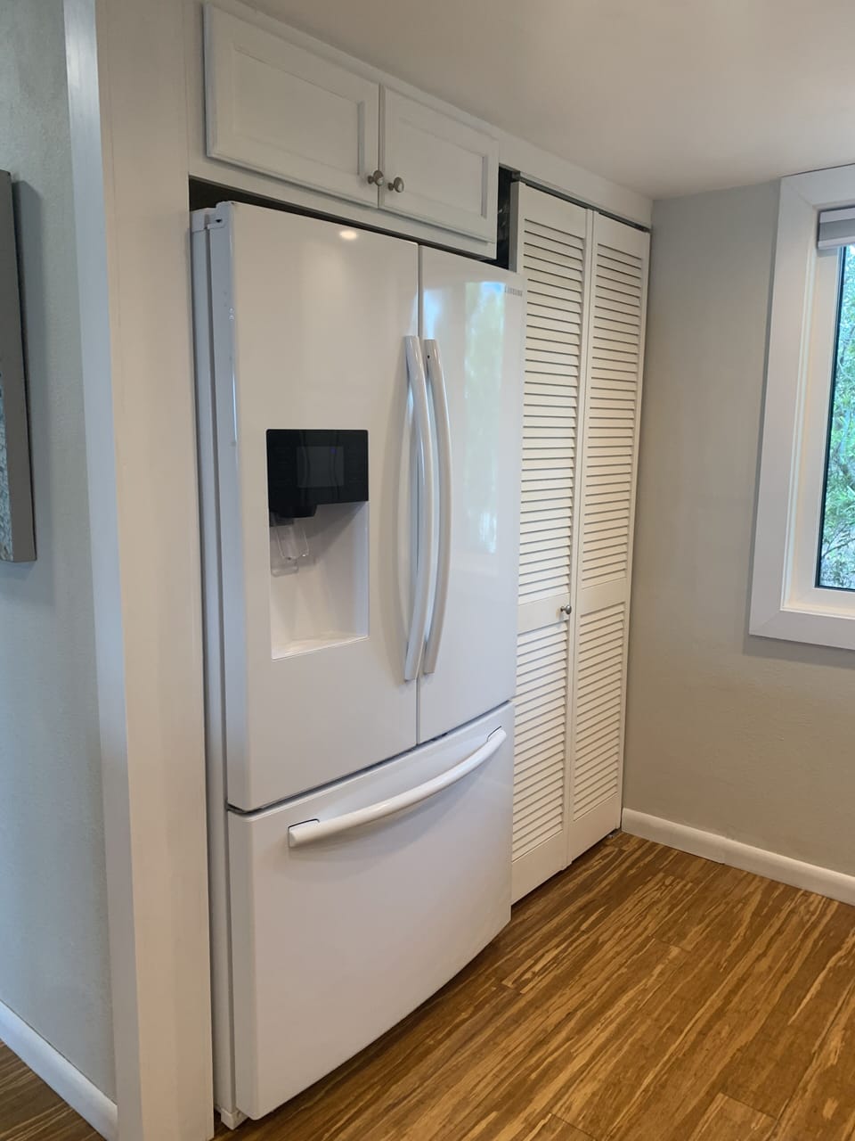 Full size refrigerator with water and ice dispenser.