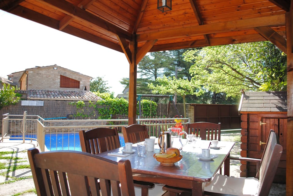 BBQ with a pergola for eating outside.