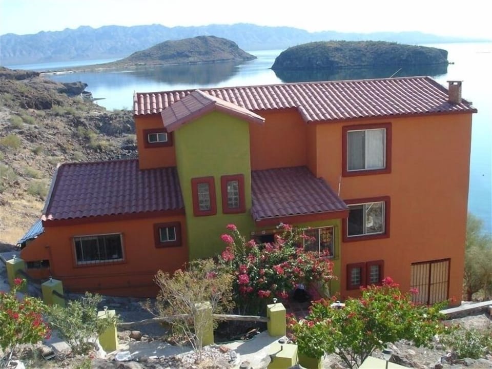 A view from our parking area shows the villa with new colors, and the bay of C 
