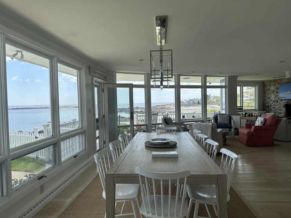 Dining table with seating for 12 directly overlooking the pool and ocean