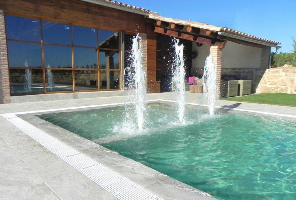 Behind the windows are a indoor Jacuzzi area