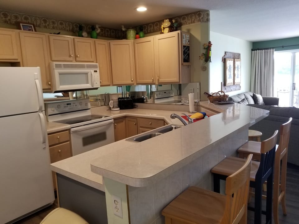 Kitchen area fully loaded. Find extra pans below stove.