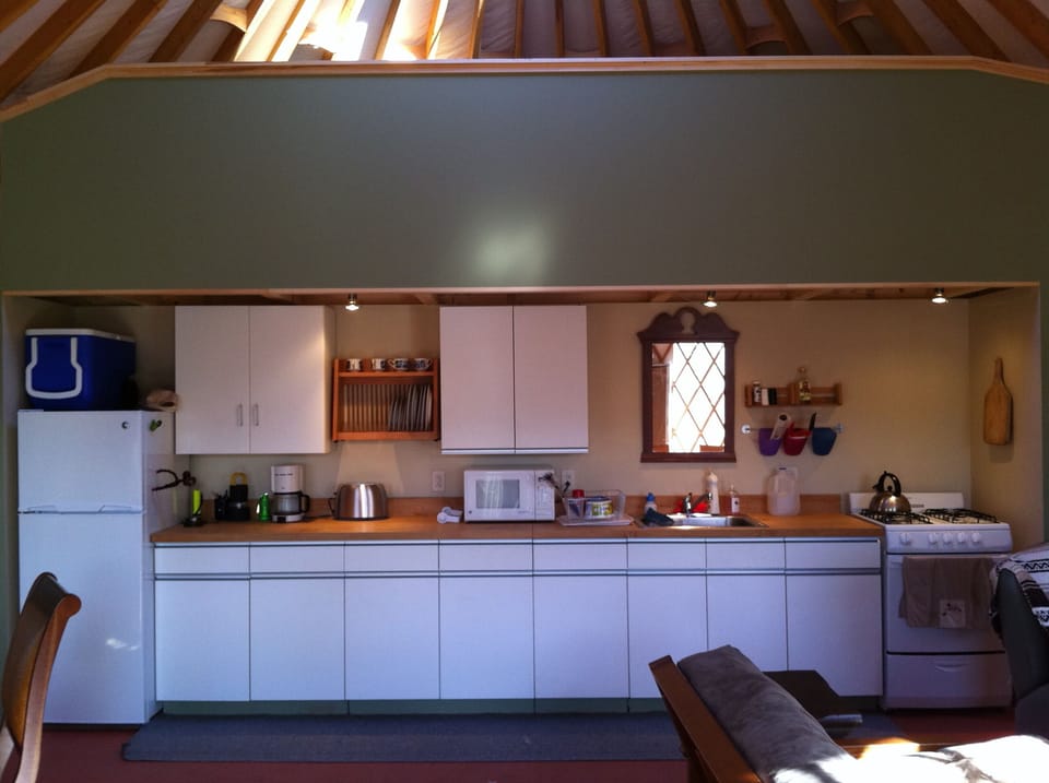 The kitchen has a full fridge, stove, microwave and lots of storage.