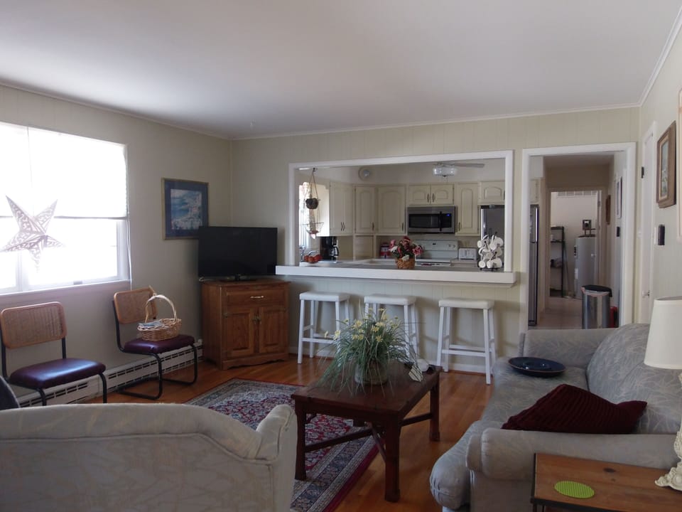 Family room with flat screen tv looking into the kitchen.