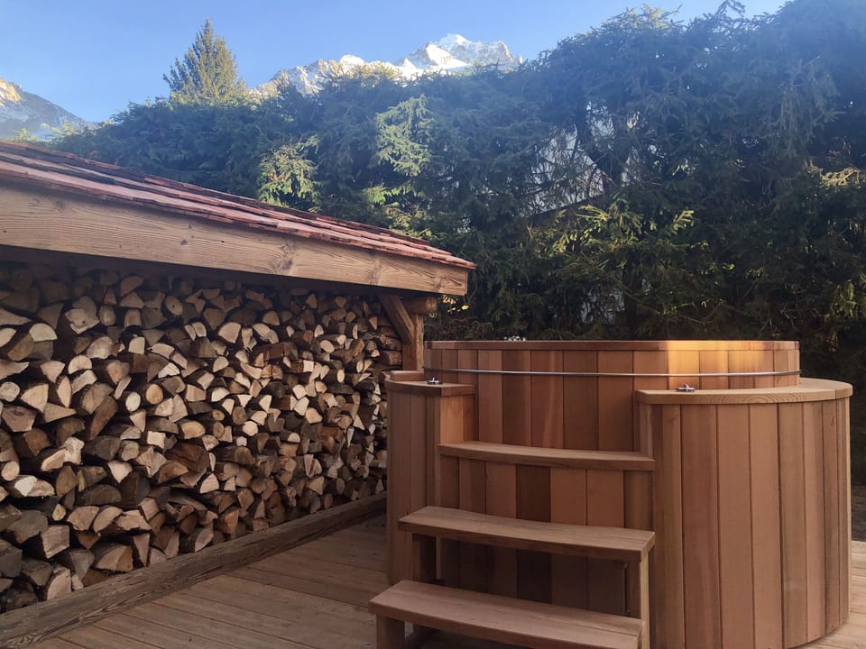 Handcrafted wooden hot tub to be enjoyed in winter and summer alike