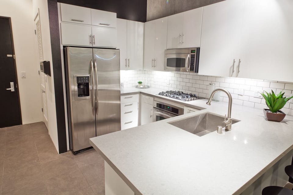 Remodeled Kitchen with Ceasarstone counters, Stainless Appliances and Subway Tile backsplash.