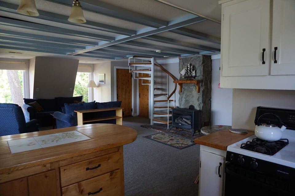 View of stairs / living room / fireplace from the kitchen