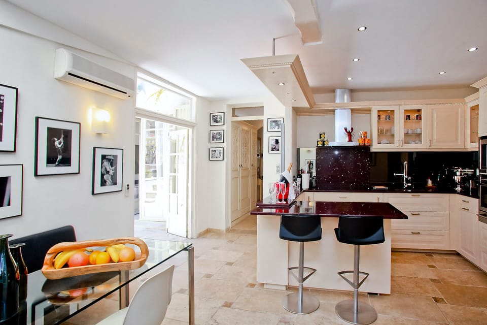 The kitchen is open towards the pool and the patio