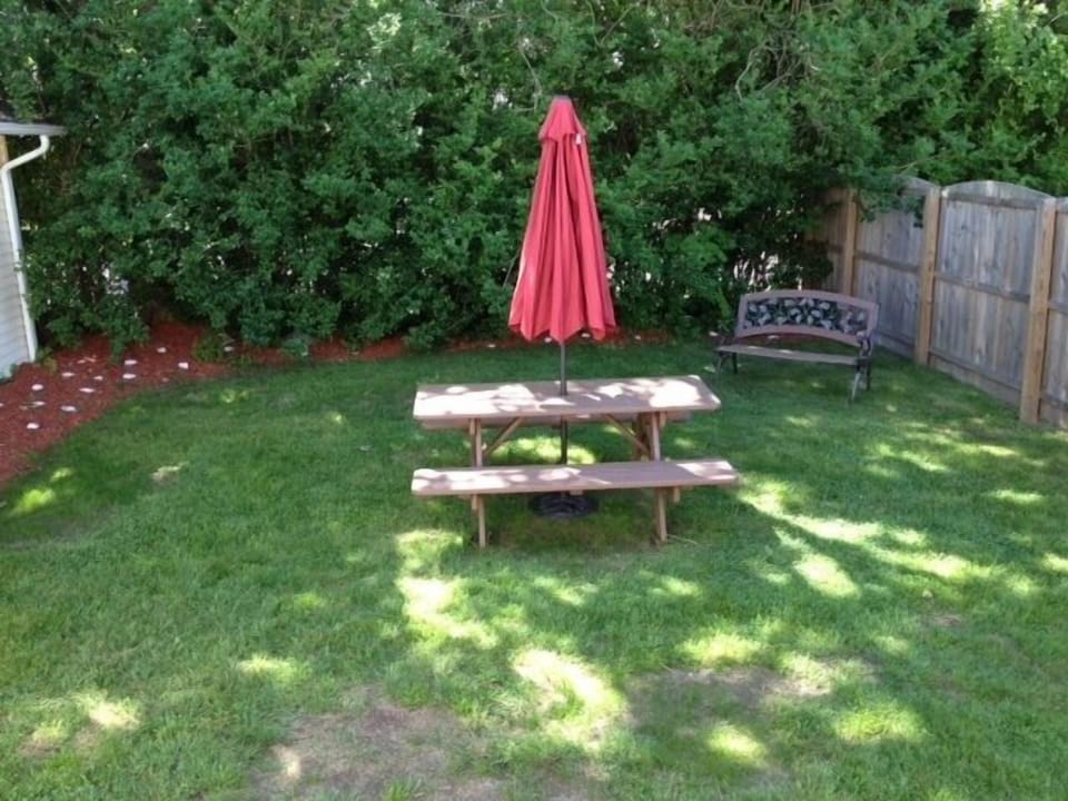 Private backyard with outdoor shower and gas grill.