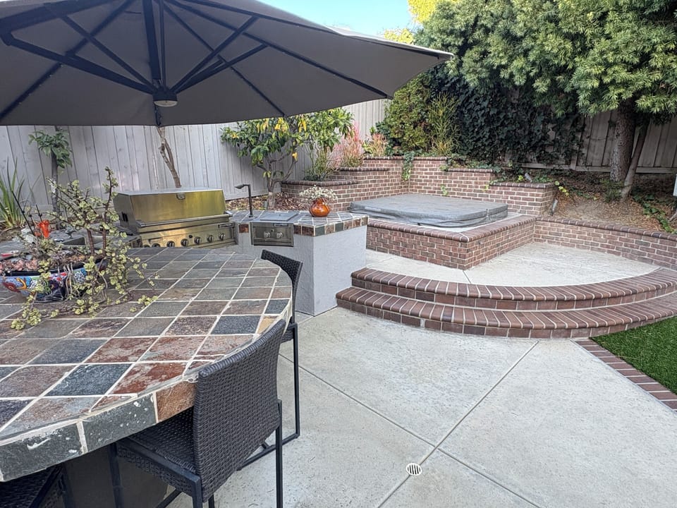 BBQ island and spa deck with 8 person hot tub