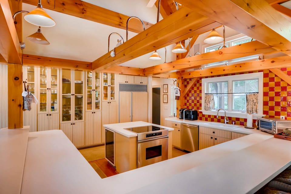 Another view of Kitchen with glasses and dishes in glass cabinets 