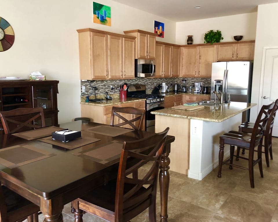 Fully equipped kitchen with stainless steel appliances and gas range.