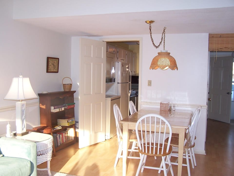 Dining area, kitchen in background