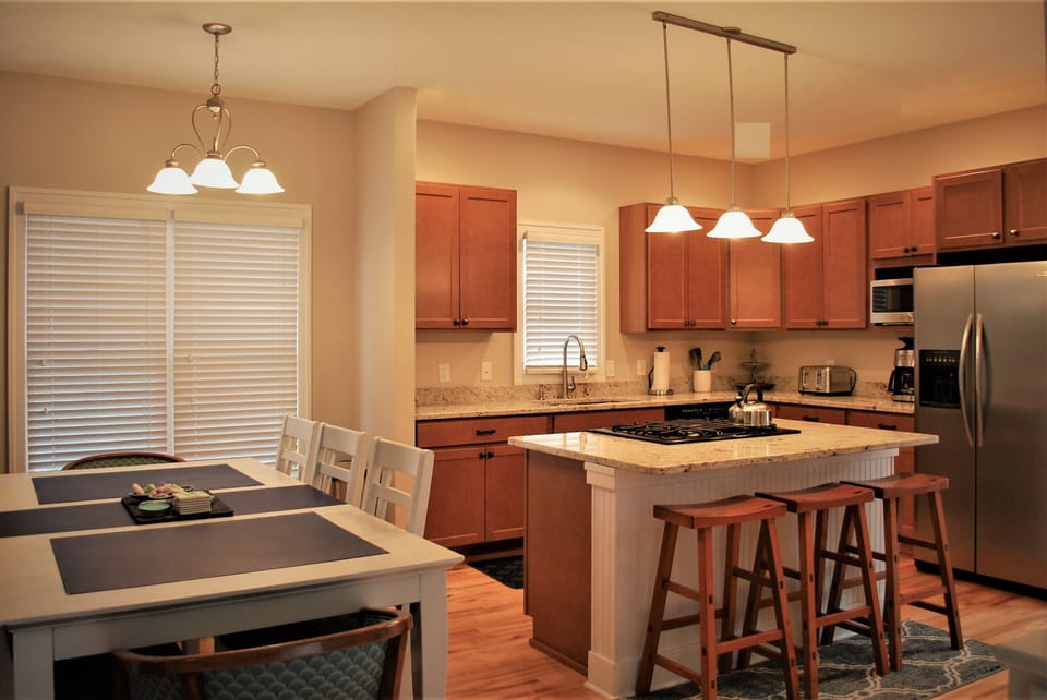 The open concept kitchen and dining room include a granite dine-in island.
