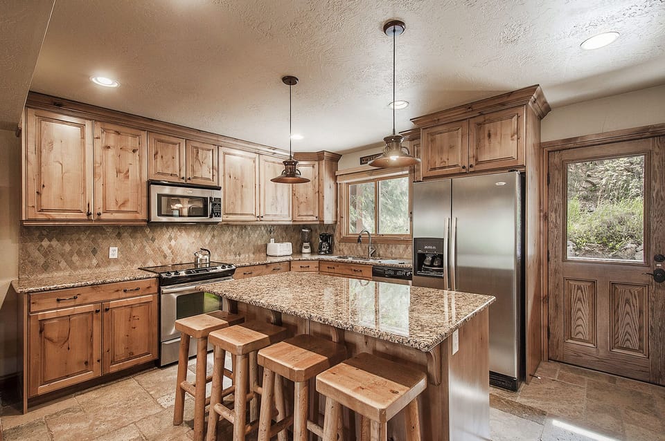 Gourmet chef's kitchen, granite counters, stainless steel appliances.