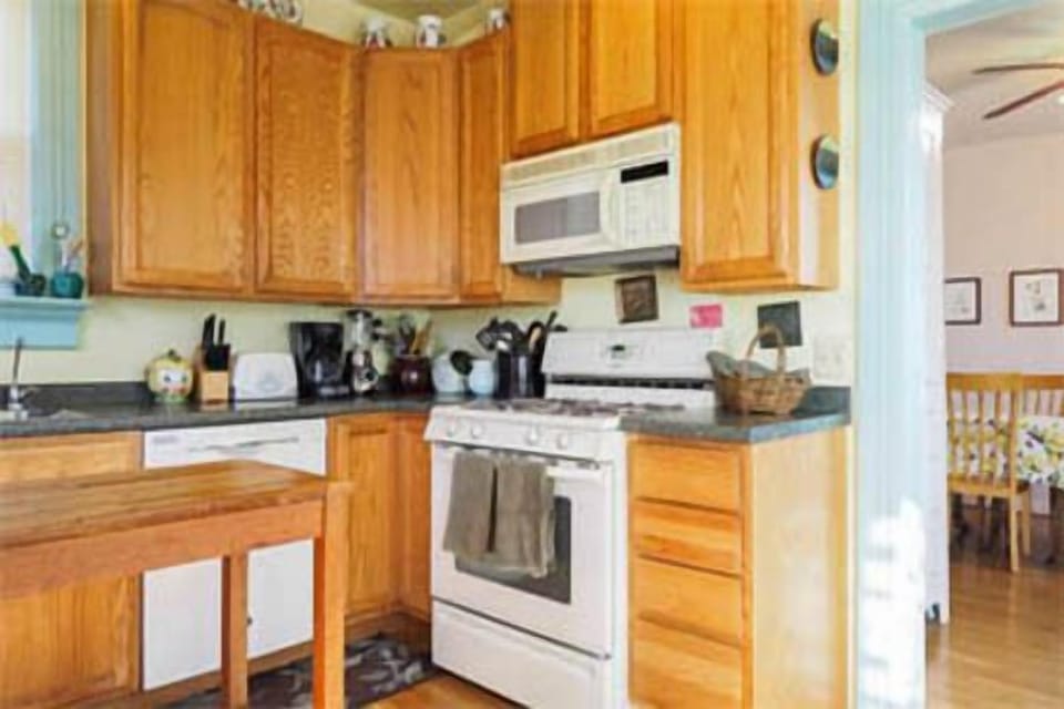 Kitchen is stocked with oil, vinegar, spices and teas.