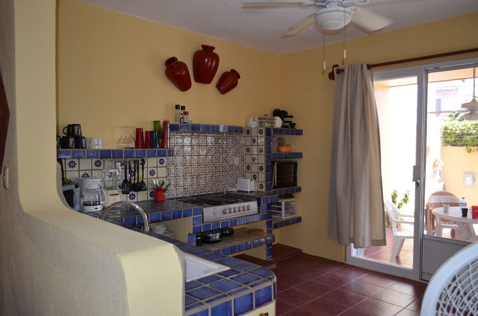 Kitchen walks out to Lanai overlooking pool and gardens