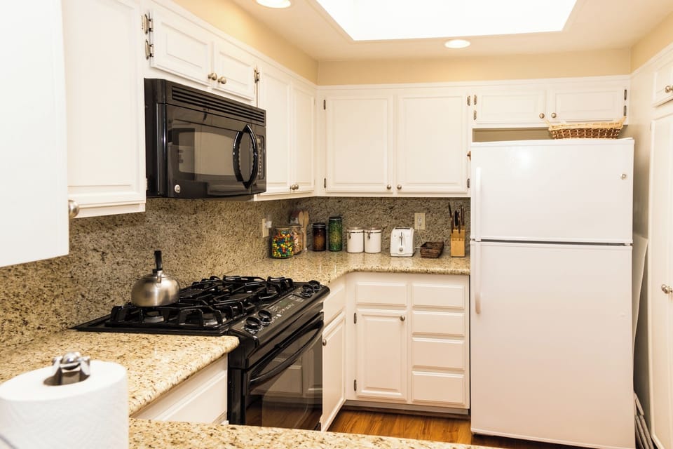 Newly upgraded, granite countertops, gas range, glorious skylight streaming down
