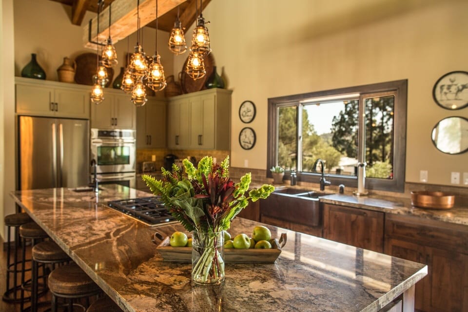 Kitchen with island, 6 burner gas range, double oven & two refrigerators