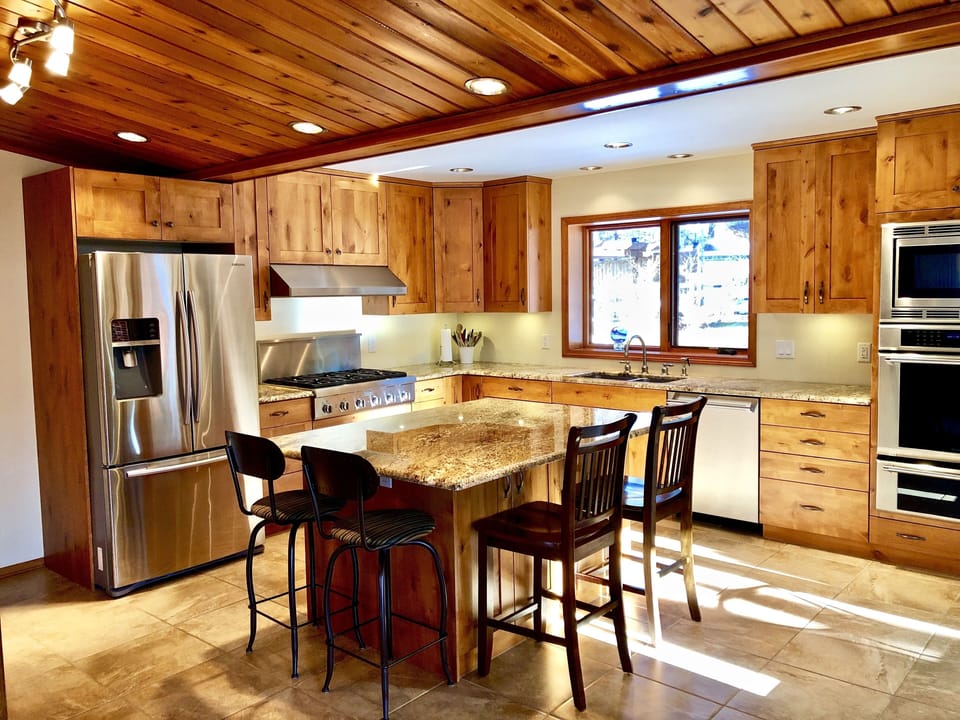Fully stocked chef's kitchen, to the right is the patio with a large Weber BBQ. 