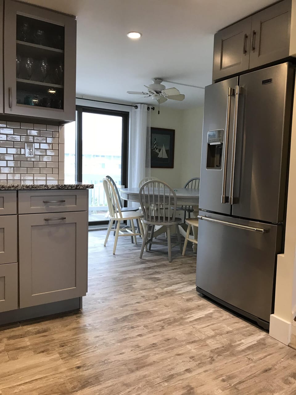 View of dining room with floor from kitchen