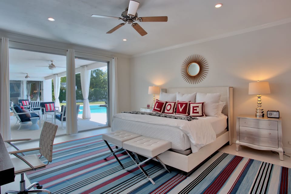 Master bedroom and private bath with direct access to pool and yard.