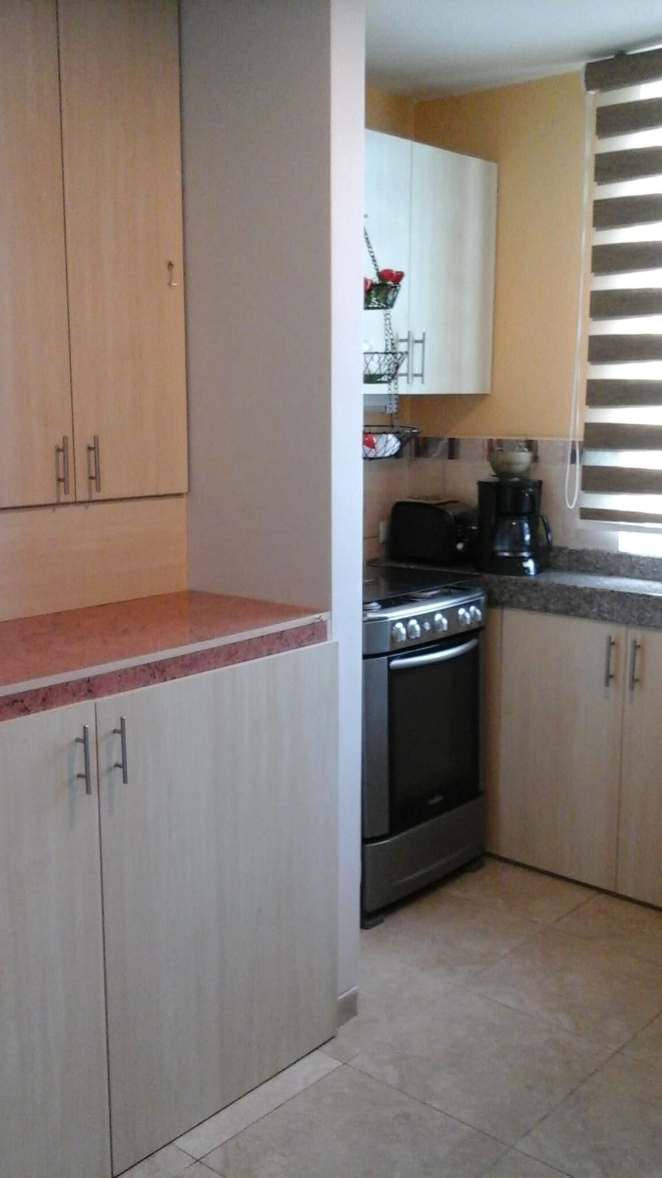 Kitchen w/hidden washer-dryer and stove counter area w/view of ocean and beach